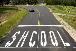 SHCOOL is painted along the newly paved road leading to Southern Guilford High School on Drake Road Monday, August 9, 2010, in Greensboro, N.C. (AP Photo/News & Record, Joseph Rodriguez) **MANDATORY CREDIT***